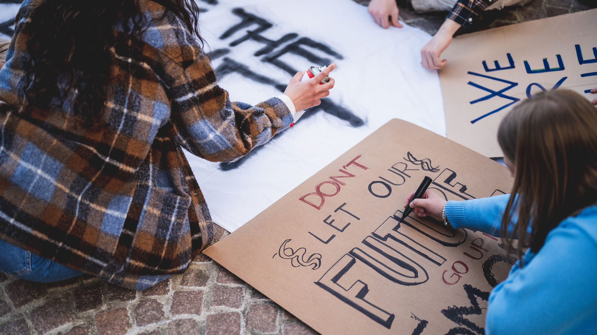 Young women creating protest signs